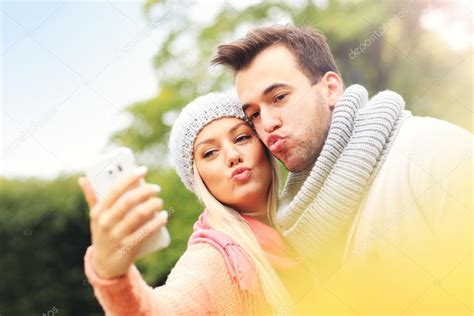 Young Romantic Couple Taking Selfie — Stock Photo © Macniak 88772384