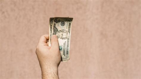 Premium Photo Cropped Hand Of Woman Holding Paper Currency