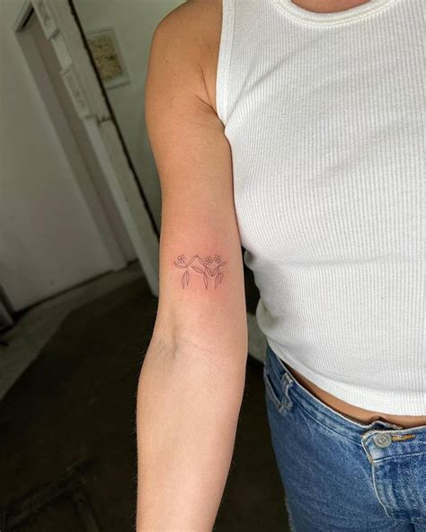 Single Needle Dancing Flowers Tattoo Located On The