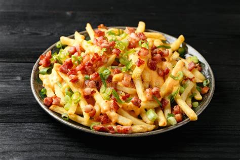 Crispy French Fries Loaded With Bacon Cheese Sauce And Spring Onion