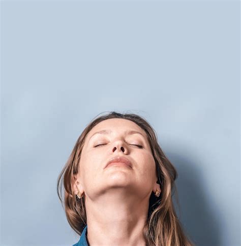 Premium Photo Portrait Of A Woman Head Looking Up On A Blue Light