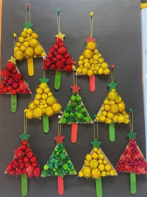 Christmas Trees Made Out Of Pom Poms Are Hanging On A Bulletin Board