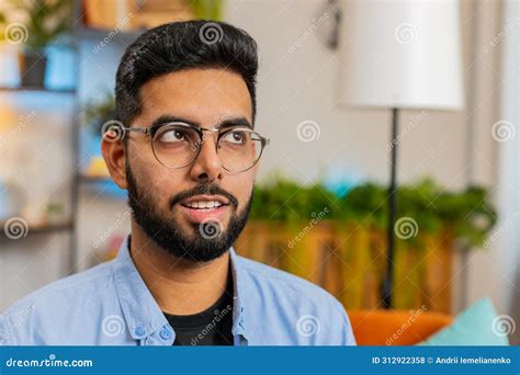 Portrait Of Happy Indian Man Looking At Camera And Smiling At Home