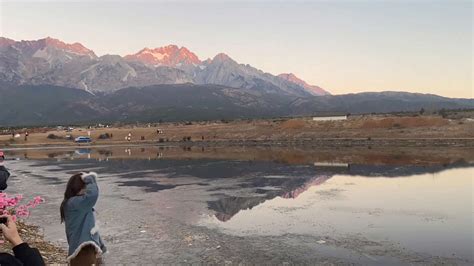 Tourists Visit The Yulong Snow Mountain at Sunset in Lijiang, China