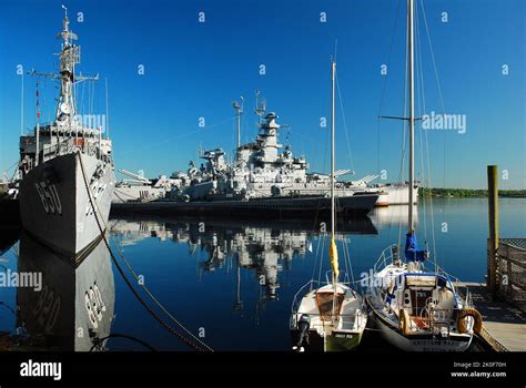 The Battleship Uss Massachusetts And Destroyer Uss Joseph P Kennedy Are Reflected Int He Still