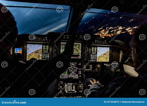 View from the Cockpit of a Modern Airplane Landing at an Illuminated ...