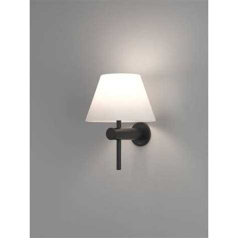 A Wall Light With A White Shade On The Top And Bottom Part Of It S Arm