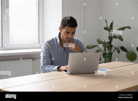 Focused Thoughtful Freelance Worker Man Thinking Over Project Stock