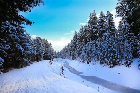 SNow Covered Beautiful Old American Rustic Country Side Landscape with Bridge, Trail and Water ...