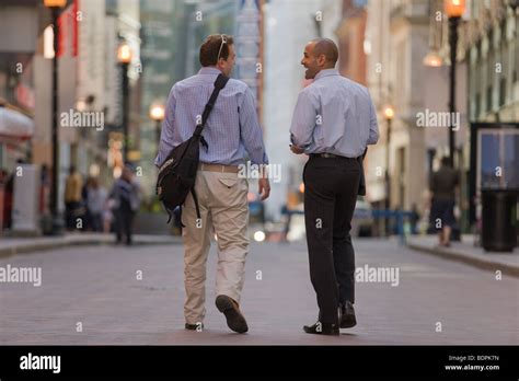 Two men walking together in a street Stock Photo - Alamy