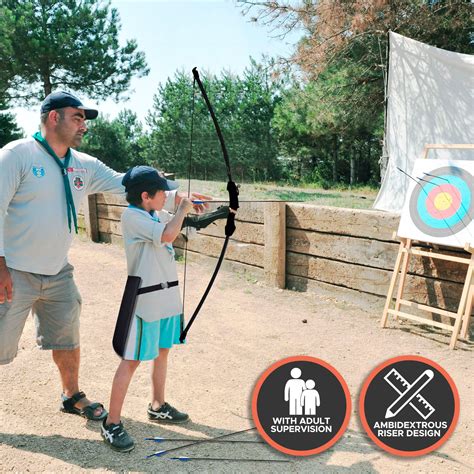 a father and son are practicing archery in an outdoor area with signs ...