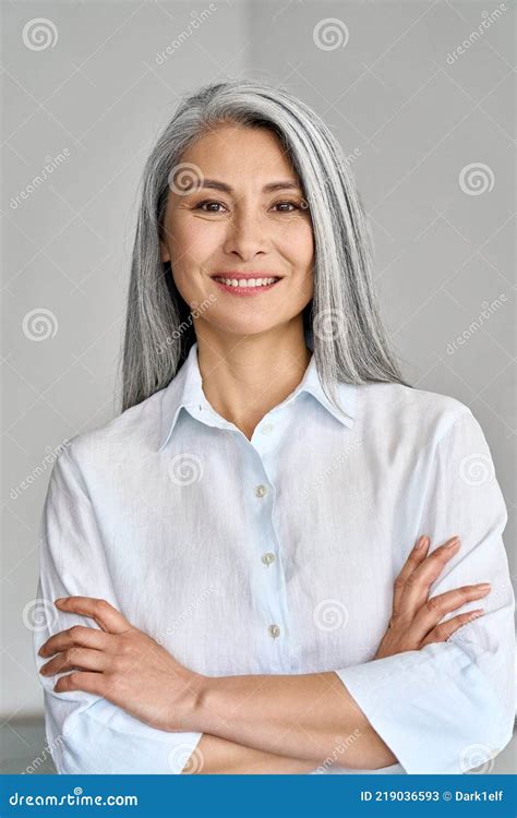 Vertical Portrait Of Mature 50 Years Asian Business Woman On Grey