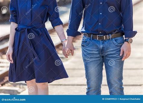 Loving Couple Holding Hands While Walking Outdoors Couple Holding The Hands Together At