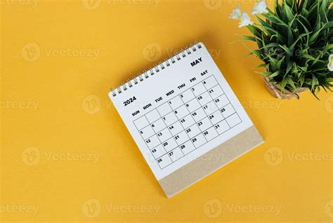 May 2024 desk calendar on yellow background. Directly above. Flat lay ...