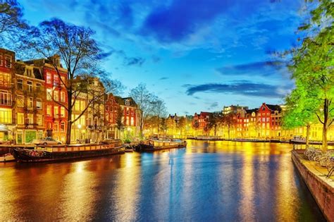 Premium Photo | Famous amstel river and night view of beautiful ...