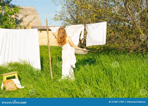 Beautiful Red Girl In Nightie Hanging Laundry Outdoors Village Woman