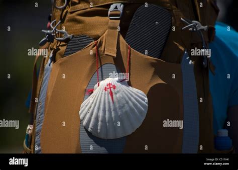 A Scallop Shell With The Cross Of Saint James Hangs In A Backpack Of A