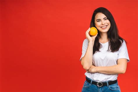 Premium Photo Young Beautiful Brunette Woman Holding Orange Fruit