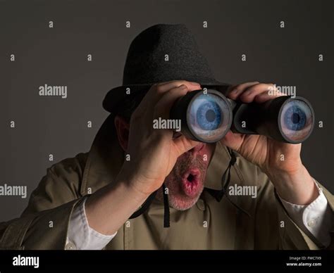 Photograph Of A Man In Trench Coat And Hat Looking Through Binoculars With Huge Cartoonish Eyes