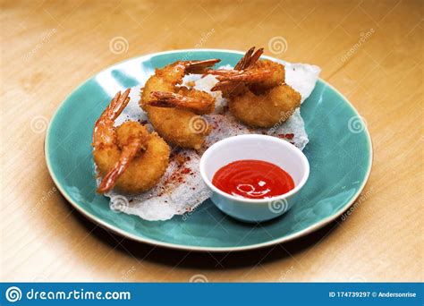 Deep Fried King Prawns With Spicy Sauce On A Blue Plate Stock Image