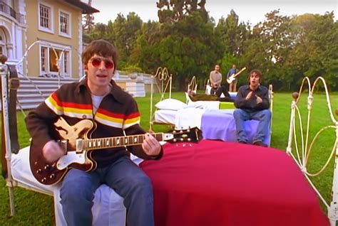 Has Anyone Noticed That Noel Gallagher Sits On A Bed With A Red Duvet