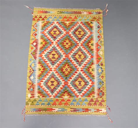 A Yellow Turquoise And White Ground Chobi Kilim Rug Th June