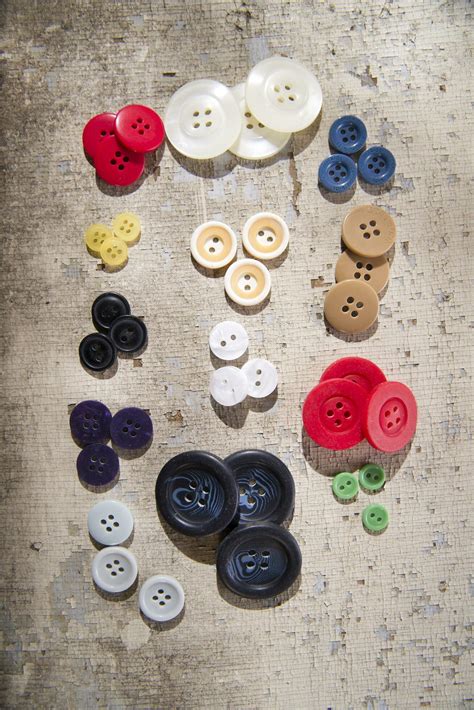 Sewing Supplies And Buttons Arranged On A White Surface Stock