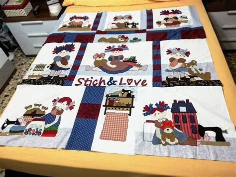 A Bed With A Quilt On It That Says Stitch And Love In The Center Along