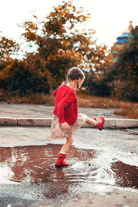 Kid Jumping Into A Puddle Stock Photo Image Of Girl 42489710