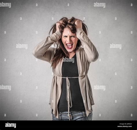 Mad Brunette Woman Yelling And Holding Her Head Stock Photo Alamy
