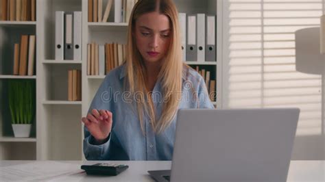 Confused Puzzled Caucasian Girl Woman At Office Counting Money Business Finance With Calculator