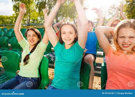 Happy Teens Hold Arms Up During Game On Tribune Stock Image Image Of