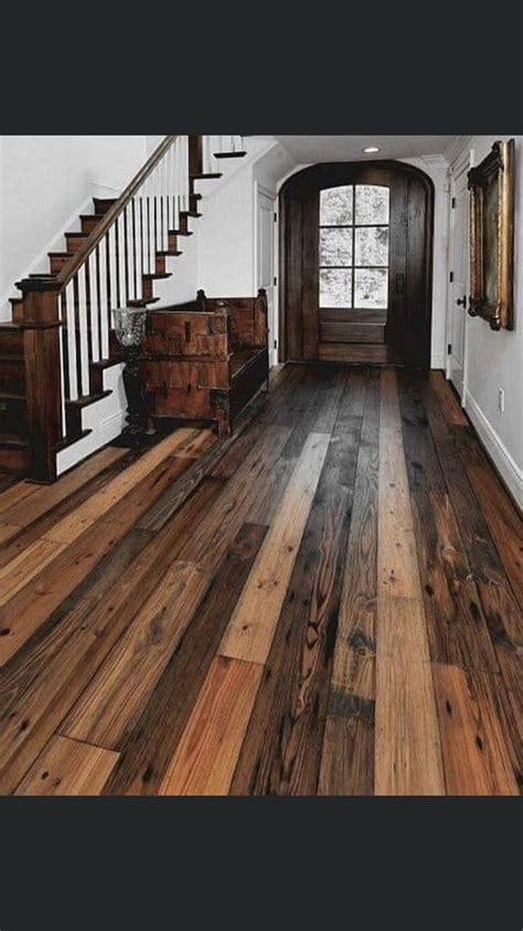 A Wooden Floor In A House With Stairs Leading Up To The Front Door And