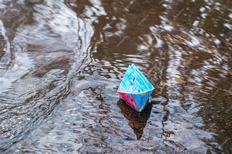 Premium Photo Multicolored Origami Paper Boats In Stream Or Puddle A