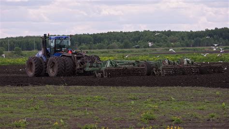 Blue New Holland T Tractor With Double Wheels Pulling Disc Harrow