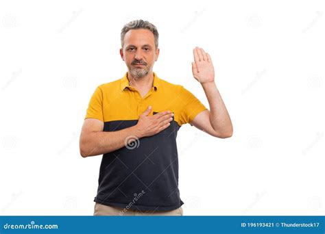 Adult Man Making Honest Oath Gesture Touching Heart Showing Palm Stock