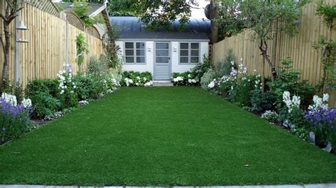 Artificial Easy Grass Lawn Summer House Sandstone Paving And White Flower Planting Scheme London