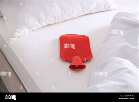 Red Hot Water Bottle On White Bed Stock Photo Alamy