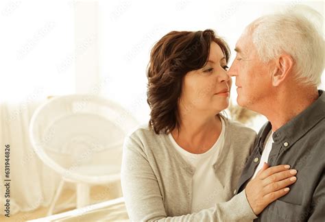 Mature 60 Year Old Couple Hugging While Sitting On The Bed In The Bedroom Stock Photo Adobe Stock