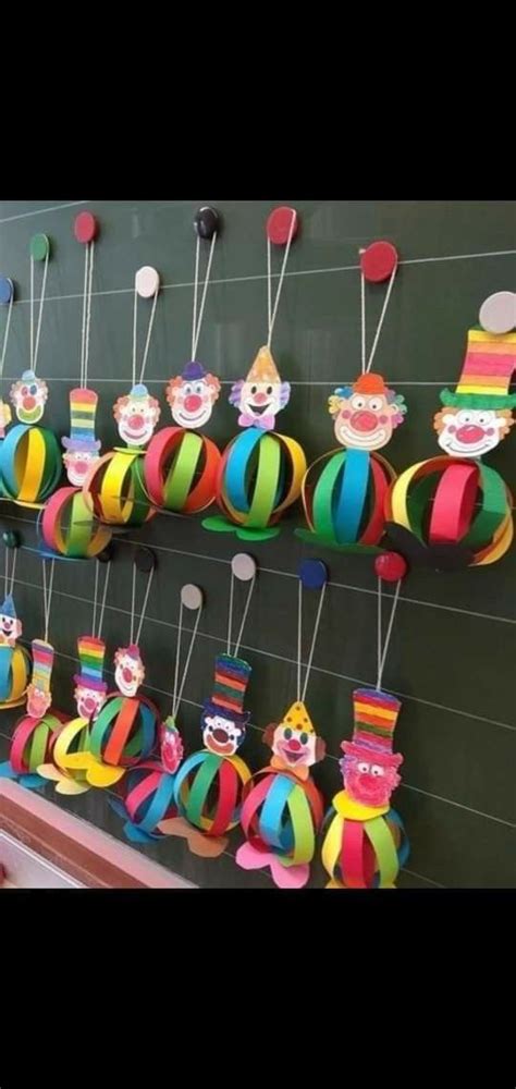 Colorful Paper Clowns Are Hanging On The Wall