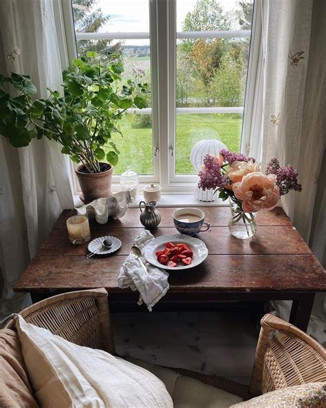 A Wooden Table Topped With Plates Of Food Next To A Window