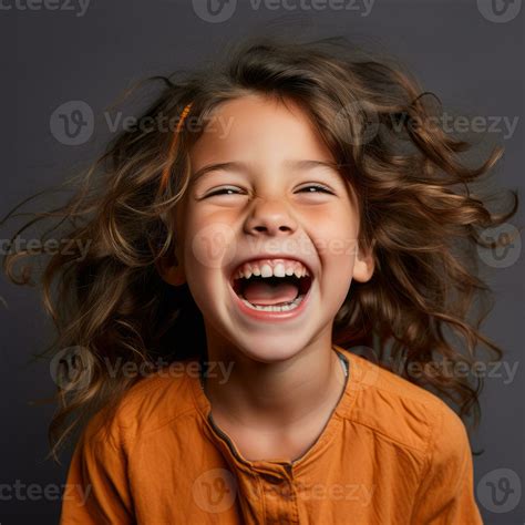 portrait of a happy little girl laughing on a dark background stock ...