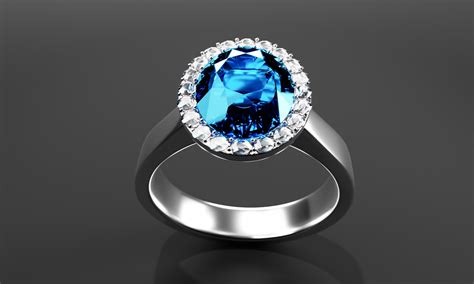 The Large Oval Blue Diamond Is Surrounded By Many Diamonds On The Ring