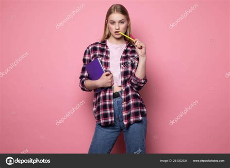 Sexy Beautiful Blonde Female Student In Casual Clothes With Purple Notebook In Hand And Yellow