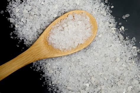 Premium Photo Sea Salt On Wooden Spoon And Dark Surface