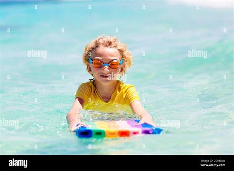 Child surfing on tropical beach. Family summer vacation in Asia. Kids ...