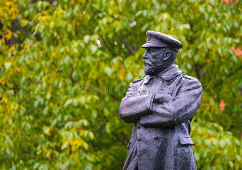 Statue To Commander Edward John Smith On The Background Of Green Trees