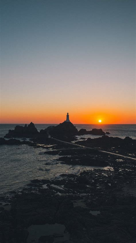 Man Standing On Rock Formation During Golden Hour Iphone 8 Wallpapers