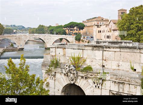 Ponte Rotto Bridge With Ponte Fabricio Bridge In Background Tiber