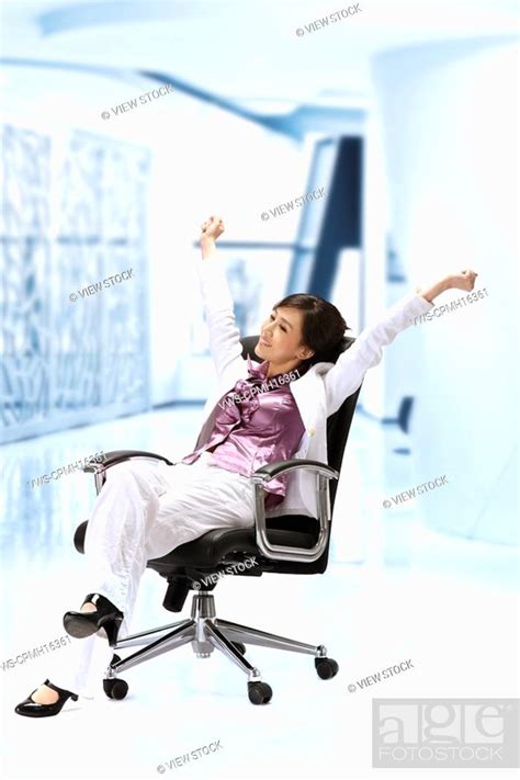 Businesswoman stretching in office chair, Stock Photo, Picture And ...